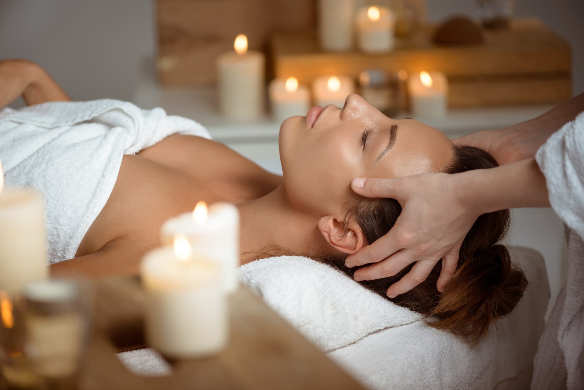 Facial massage by candlelight during the Signature Glow ritual