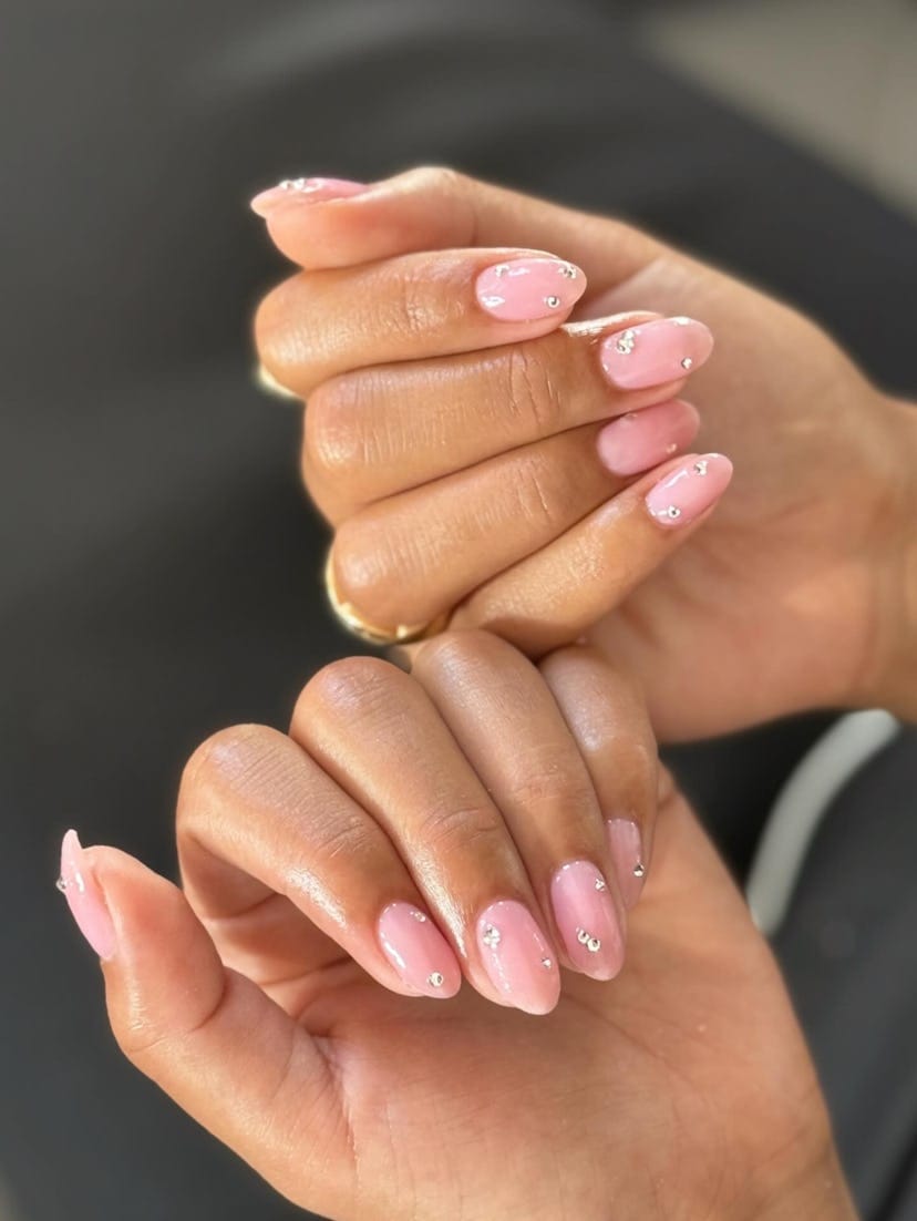 Glossy pink almond nails with fine detail