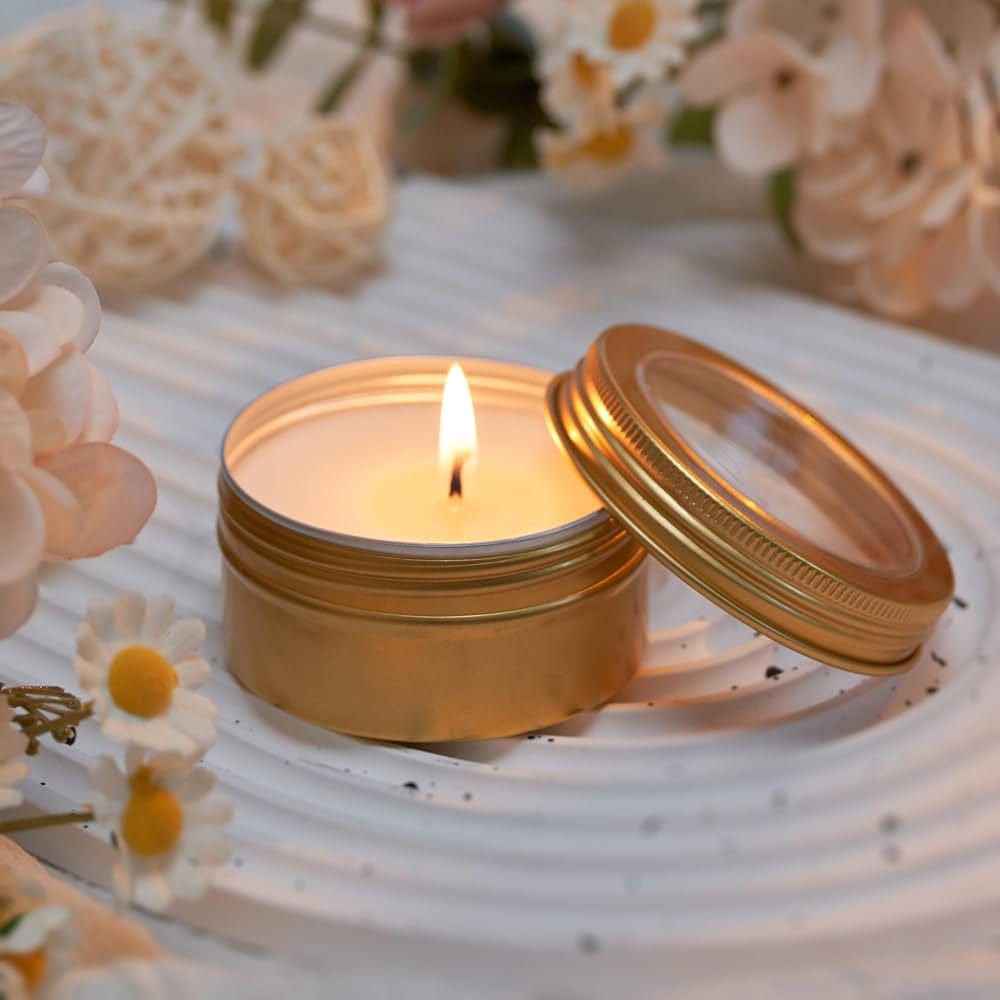 A lit candle among white flowers